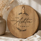 Personalised round acacia serving board engraved with a custom family name, styled with neutral home décor in soft natural light.
