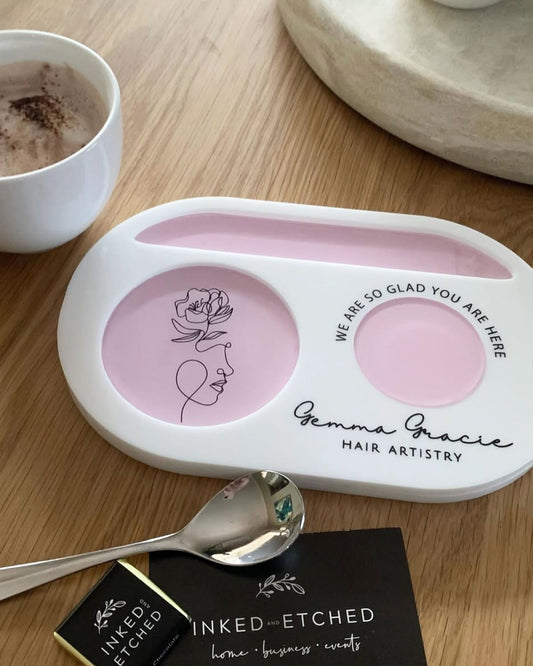 White and pink acrylic cup tray with logo and branding. The welcoming tray says 'we are so glad you are here'. 