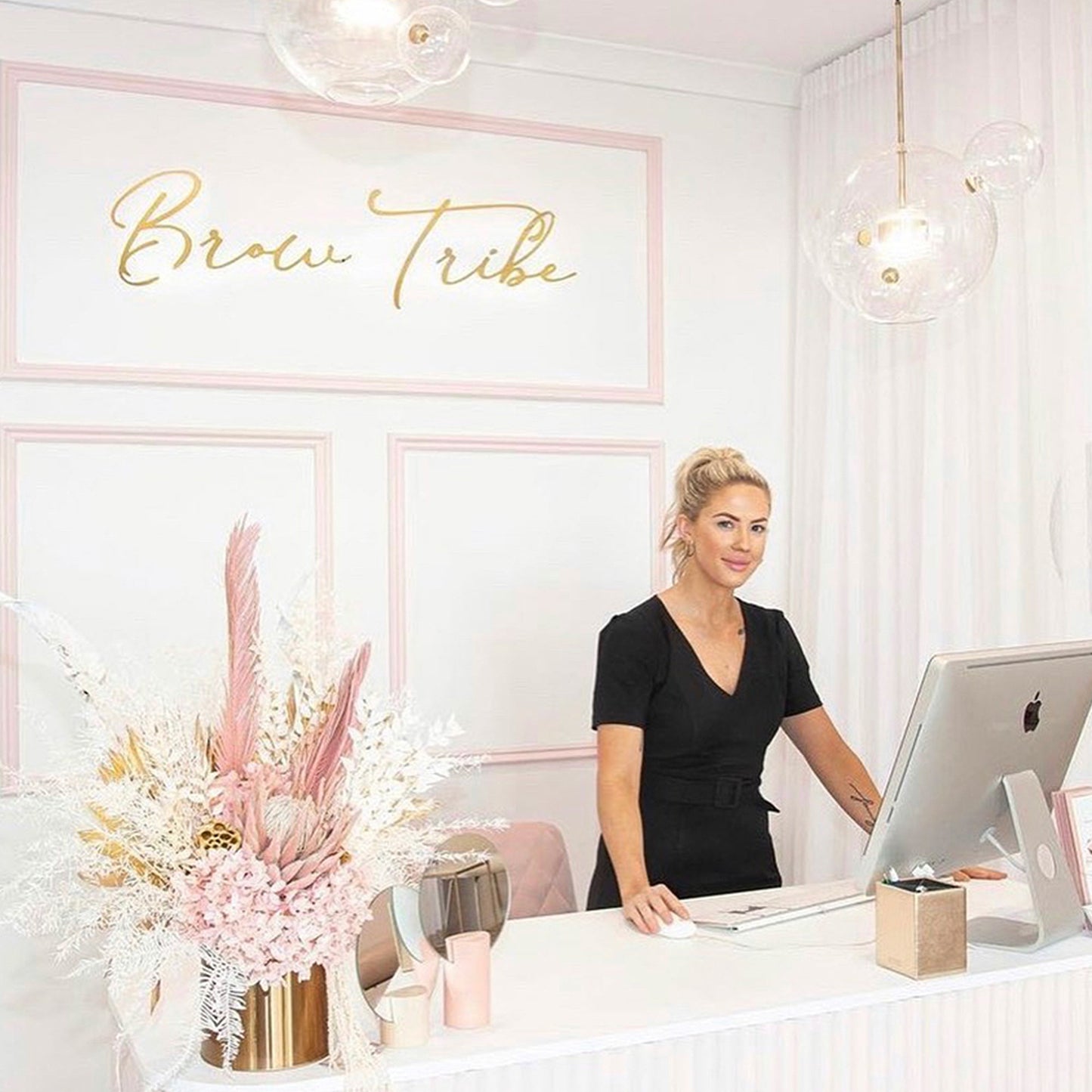 Custom acrylic logo sign featured in a stylish beauty salon reception to showcase professional wall branding.