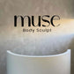 Black acrylic logo sign mounted on a textured reception wall providing sleek custom business wall branding.