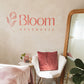 Blush pink acrylic logo sign displayed on the wall of a modern aesthetics clinic with premium custom business branding.