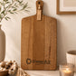 Business branded paddle serving board engraved with SlaterAir logo displayed in a warm modern interior.