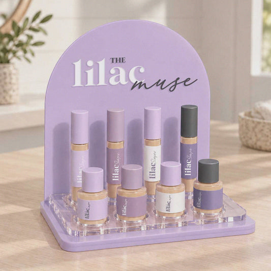 Custom acrylic makeup display stand with logo and eight cosmetic bottle holders.