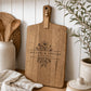 Custom charcuterie board engraved with personalised names displayed in a modern kitchen, handcrafted from premium acacia timber.