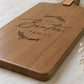 Close-up of a personalised family serving board engraved with a custom surname on premium acacia timber.