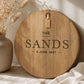 Custom family name serving board engraved with surname and wedding date displayed in a neutral styled home.