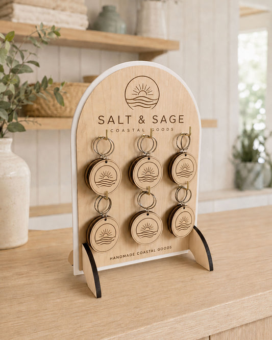 Custom logo keyring display stand set with white acrylic border and 12 round engraved wooden business keyrings.
