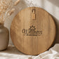 Branded acacia serving board engraved with a business logo, photographed in warm natural light.