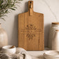 Personalised custom charcuterie board with floral engraving on premium acacia timber styled on a marble kitchen benchtop.