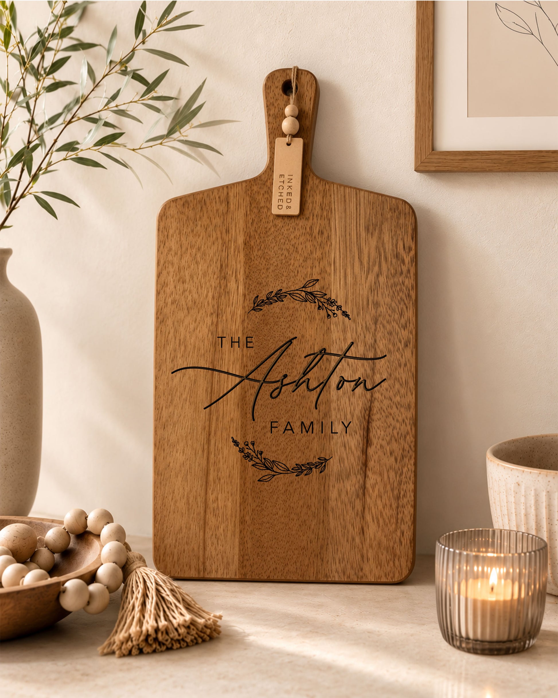 Engraved personalised family cheeseboard made from acacia timber styled in a contemporary kitchen.