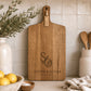 Engraved paddle cheeseboard personalised with couple's initials and names on premium acacia timber