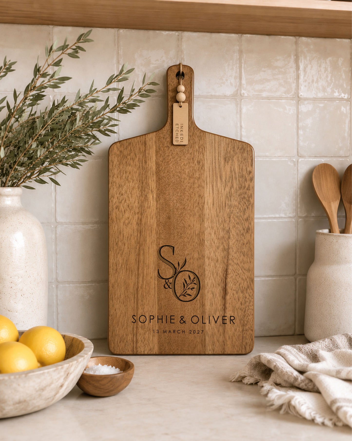 Engraved paddle cheeseboard personalised with couple's initials and names on premium acacia timber