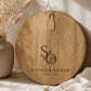 Custom engraved acacia cheeseboard personalised with initials and names, perfect wedding gift for couples.