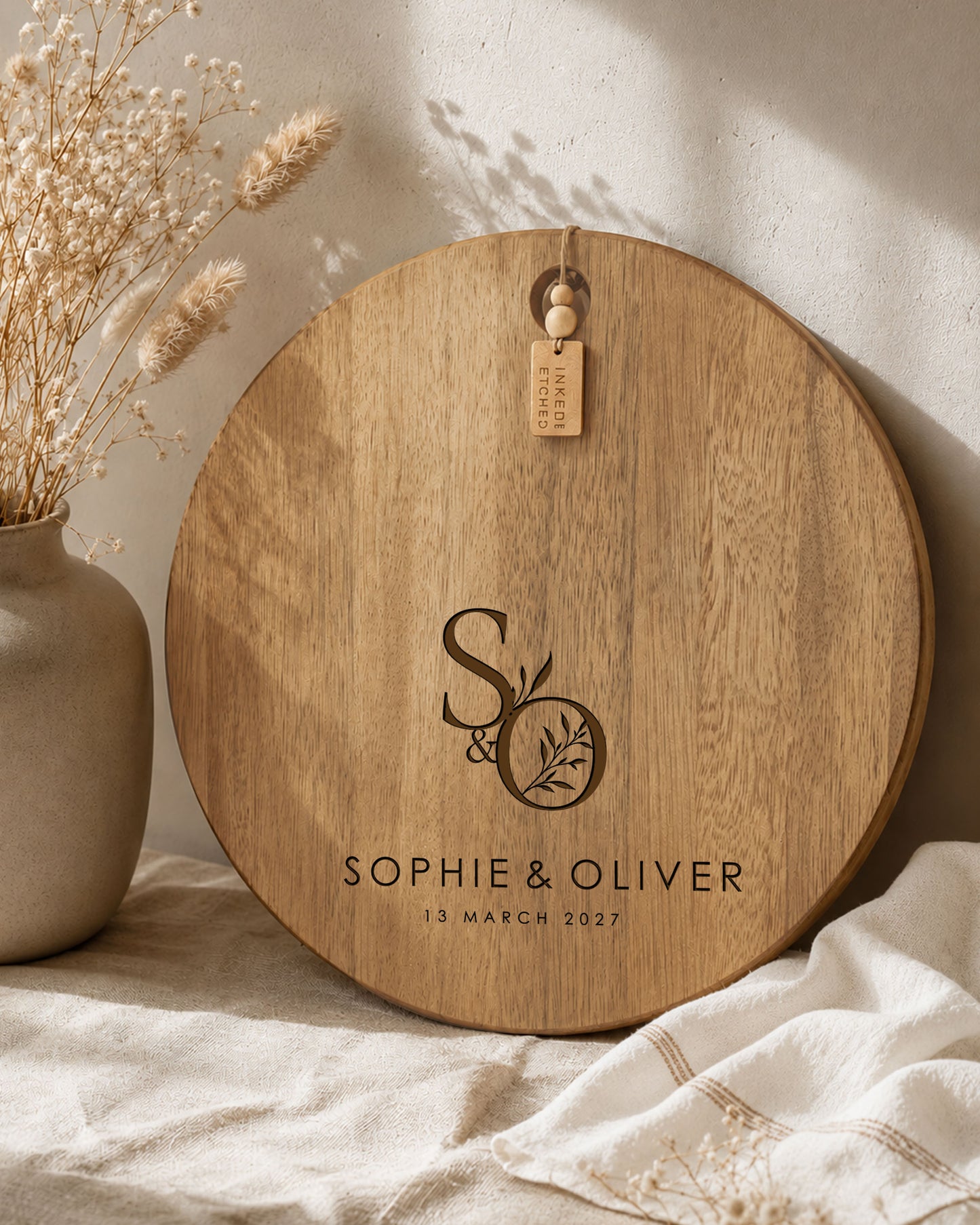 Custom engraved acacia cheeseboard personalised with initials and names, perfect wedding gift for couples.