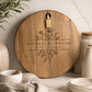 Custom engraved acacia wedding cheeseboard displayed in a modern kitchen with neutral styling.