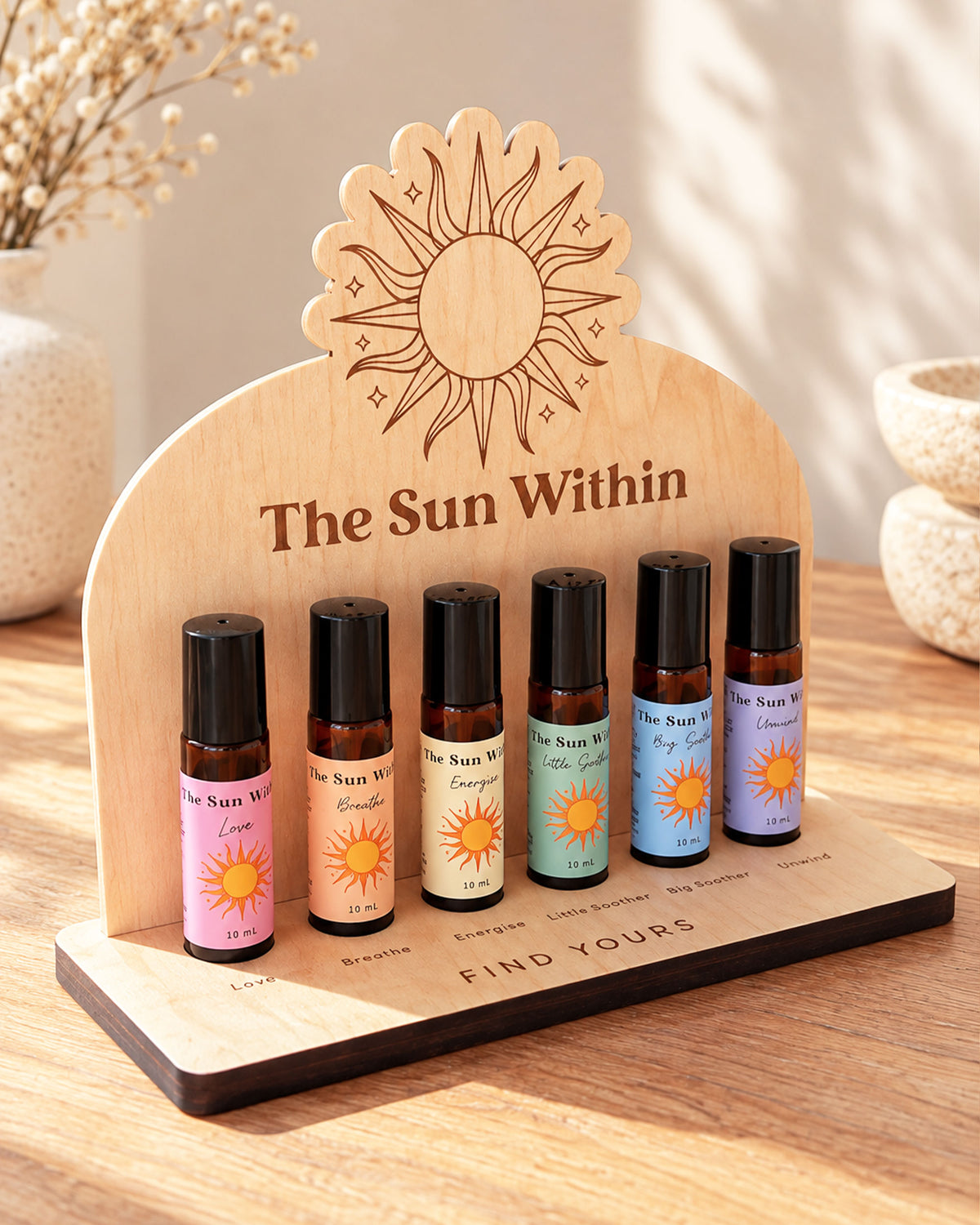 Close-up display of a bohemian style wooden essential oil organizer featuring an intricate sun motif engraving at the top.