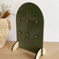 Rear view of an olive green keyring display stand with timber feet.