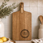 Personalised cheeseboard engraved for a 70th birthday, custom acacia serving board with milestone birthday design.