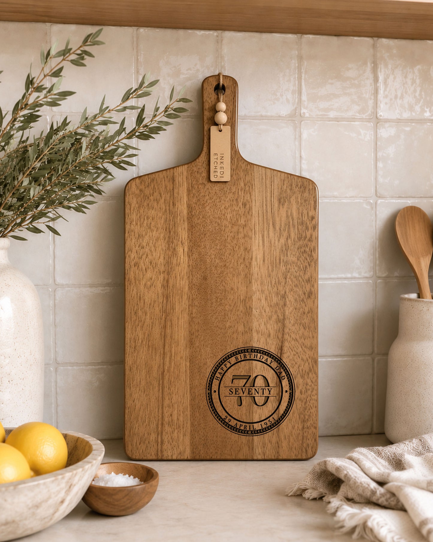 Personalised cheeseboard engraved for a 70th birthday, custom acacia serving board with milestone birthday design.