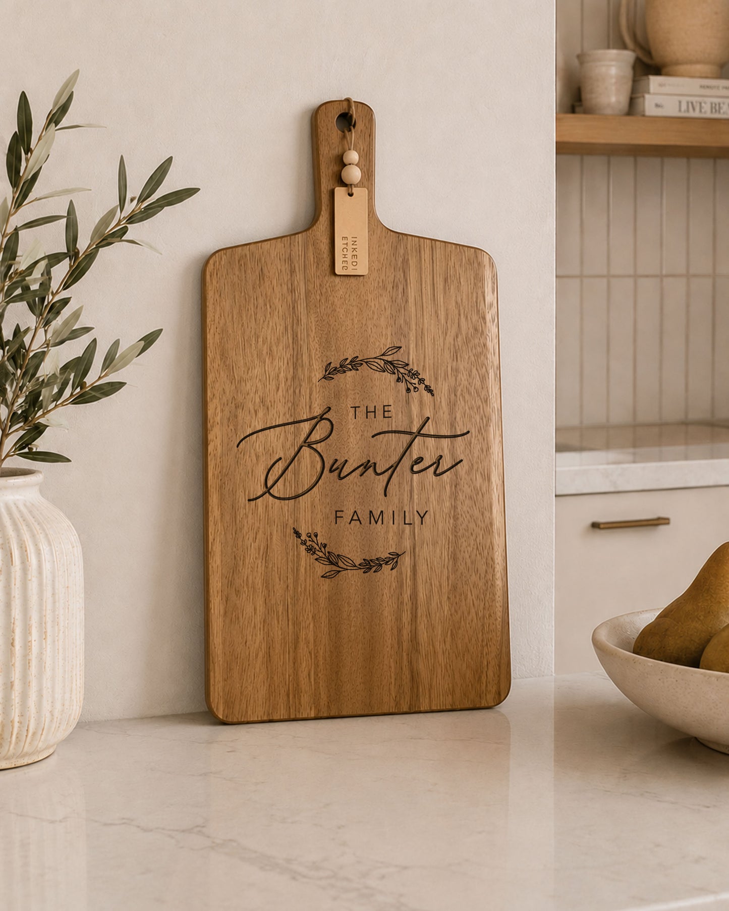 Custom charcuterie board engraved with a personalised family name, handcrafted from natural acacia timber for serving and entertaining.