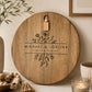 Round personalised floral cheeseboard with engraved names styled as a decorative serving board in a modern home.