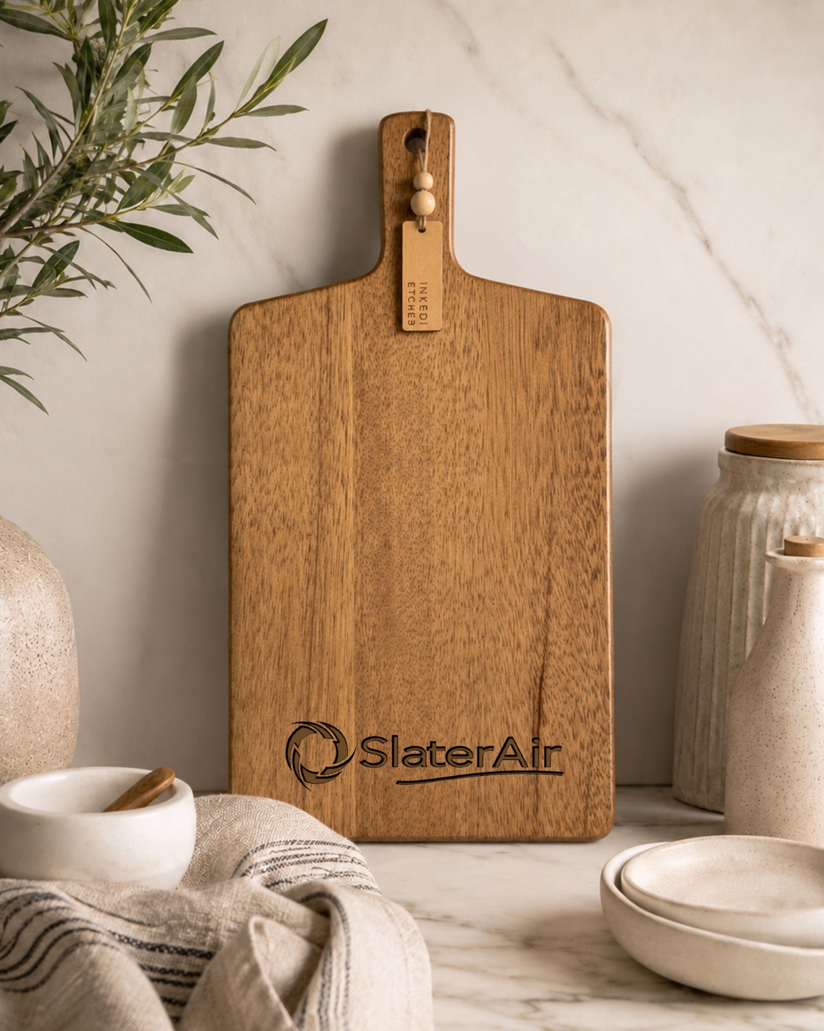 Custom engraved SlaterAir logo on premium acacia paddle serving board for corporate branding.