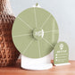 Green acrylic Spin The Wheel prize wheel with white section lines and a matching mini sign on a white stand.